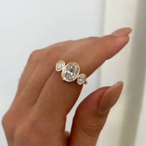 Oval lab grown diamond engagement ring 14K yellow gold Dubai 2.50 CT IGI certified trilogy setting handcrafted UAE